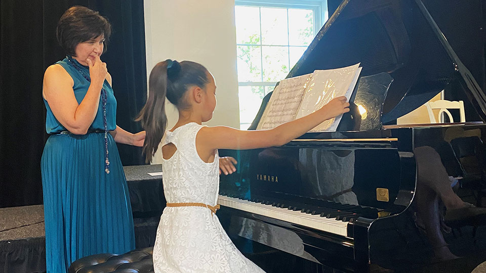 luda-teaching-piano-to-student